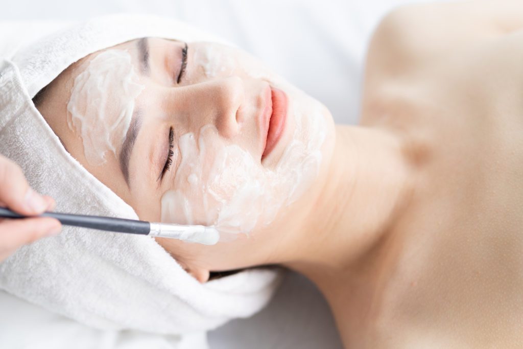 photo of woman getting facial treatment