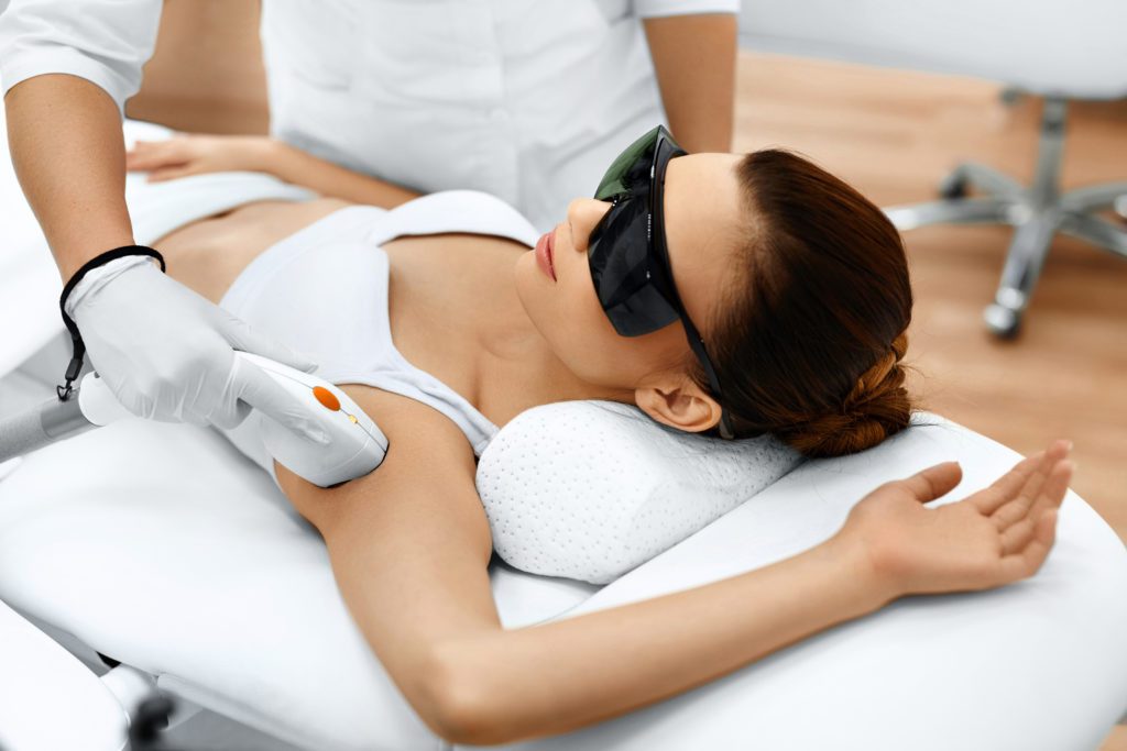 woman getting armpit laser hair removal treatment