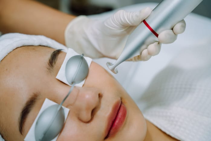 woman getting facial laser treatment