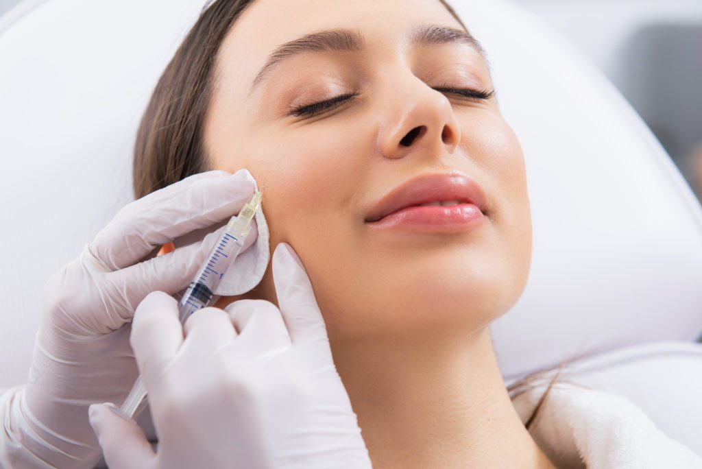 photo of woman getting cheek filler injection
