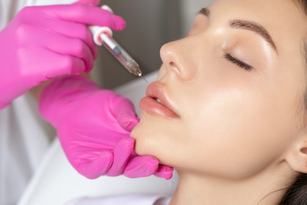 photo of woman getting lip filler injection