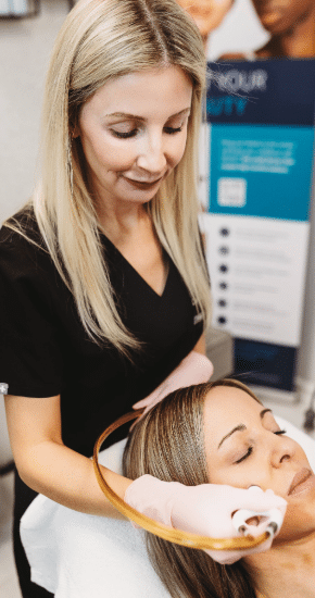 Chelsey performing a face treatment